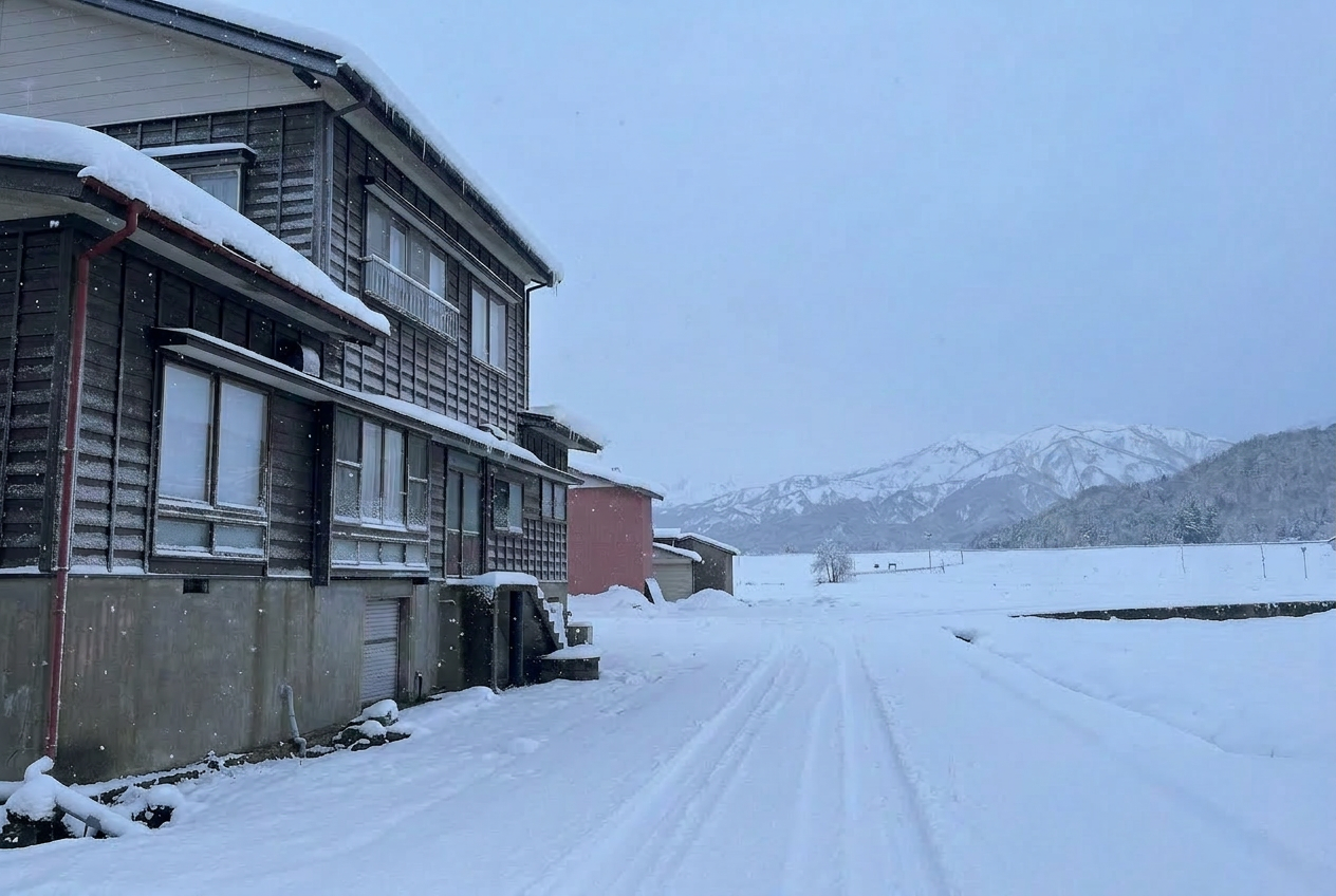 Traditional Japanese lodge in deep snow at night